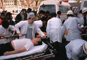 Rescue workers and medical personnel attend to subway passengers in Tokyo